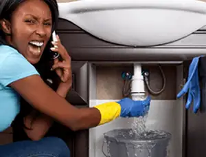 Emergency plumbing repair for a leaking sink drain under a bathroom vanity in Chattanooga, TN