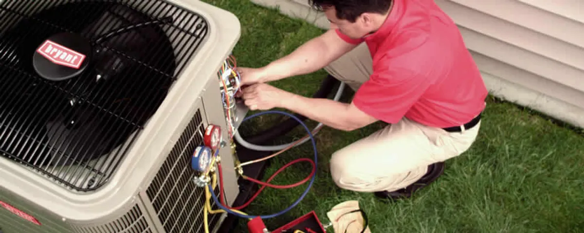 HVAC technician servicing an outdoor air conditioner unit in Chattanooga, TN