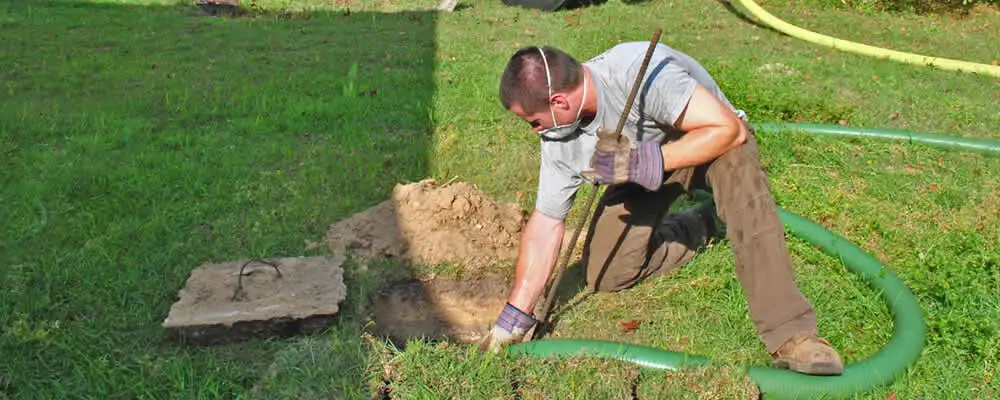 Septic pumping technician servicing a residential septic tank in Chattanooga, TN