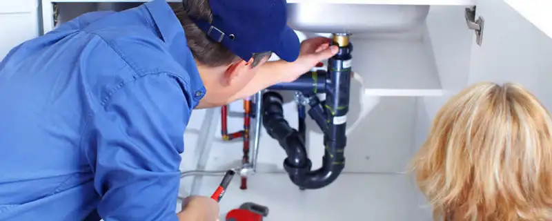 Plumber repairing under-sink drain pipes and fittings in Chattanooga, TN
